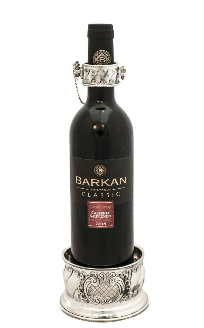 925 STERLING SILVER HANDMADE CHASED PATTERNED ELEGANT BOTTLE HOLDER: 925 STERLING SILVER HANDMADE CHASED PATTERNED ELEGANT BOTTLE HOLDER Fine 925 Sterling Silver Bottle Holder. Featuring handmade open chased patterned elegant designs. Silver Weight: 325 Grams Dimension