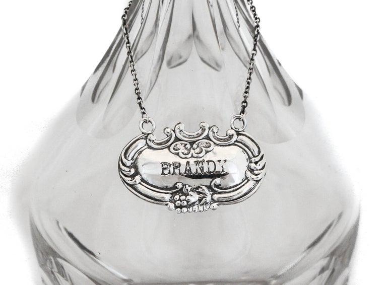 Sterling "Brandy" Liquor Label: Sterling "Brandy" Liquor Label Creator:: Wallace Silversmiths (Manufacturer) Dimensions:: Height: 1 in (2.54 cm) Dimensions:: Diameter: 2 in (5.08 cm) Materials and Techniques:: Sterling Silver Place