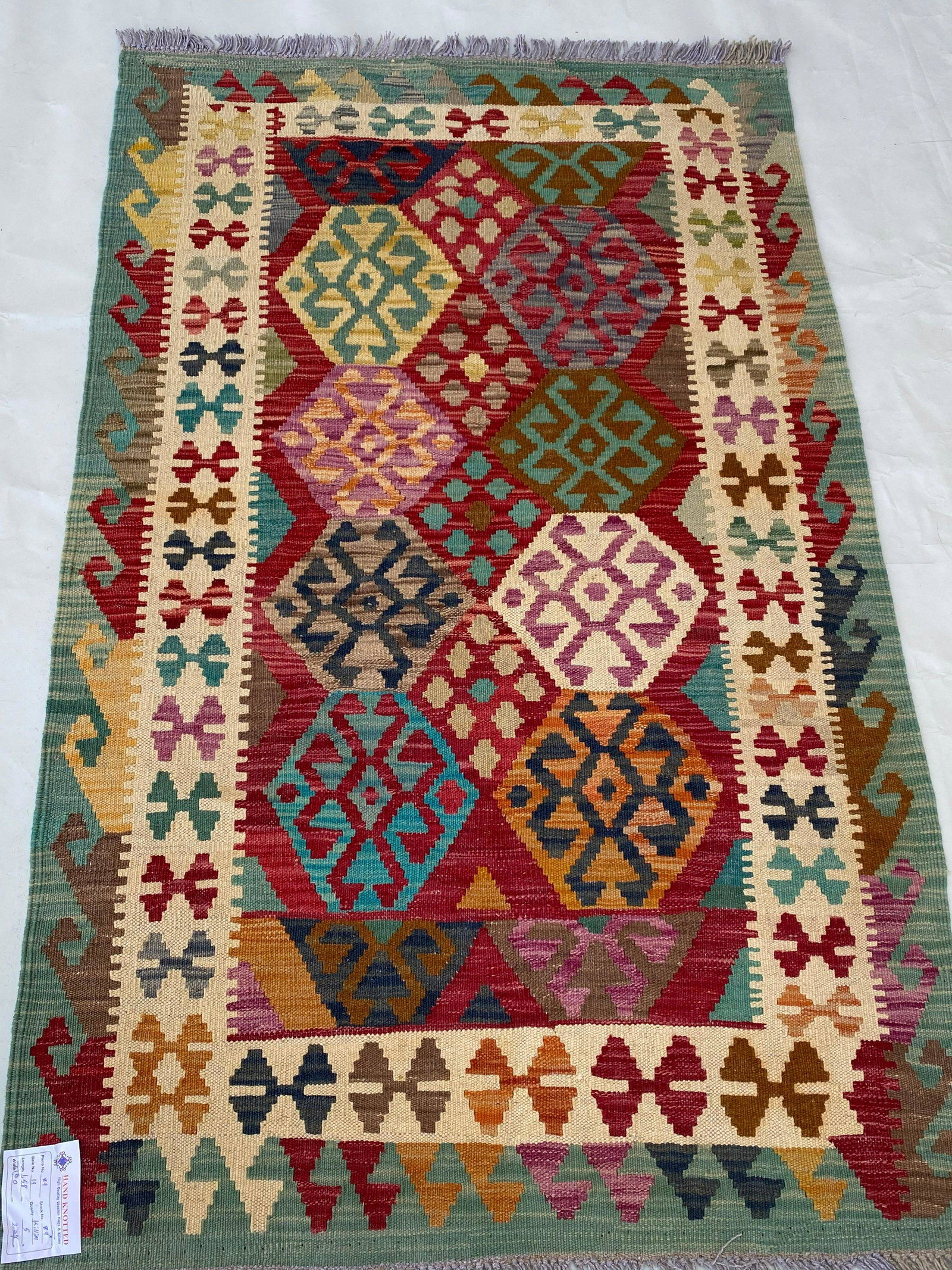 3' x 5' Red Kilim Rug: 3' x 5' Red Kilim Rug Size in Feet: Width: 3 x Length: 5 Size in Inches: Width: 36 in x Length: 60 in Colors: Red Ivory Fern Green Weave: 100% Handmade Style: Geometric Origin: Afghanistan Condition: 