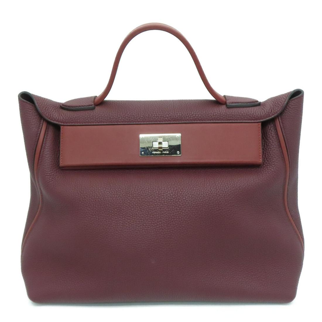Hermes PHW 24/24 Handbag Togo Leather Swift leather Bordeaux Red: Hermes PHW 24/24 Handbag Togo Leather Swift leather Bordeaux Red Exterior Material: Calfskin (cowhide) Style: Handbag Exterior Color: Red Hardware Color: Silver Bag Height: 10.2 Bag Depth: 6.5 Bag Len