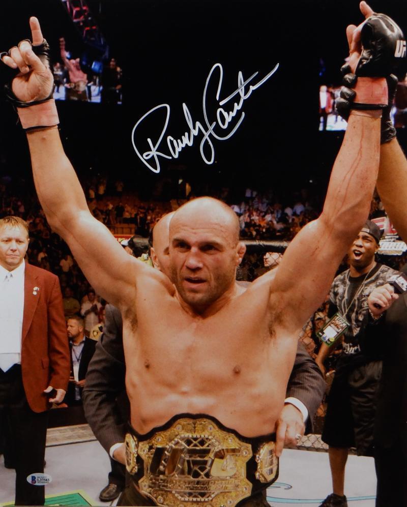 Randy Couture Autographed UFC 16x20 With Belt Photo- Beckett *White: Randy Couture Autographed UFC 16x20 With Belt Photo- Beckett *White Autograph Authentication: Beckett/ Player: Randy Couture Original/Reprint: Original Sport: Mixed Martia Pre-Owned PLEASE NOTE: Frame