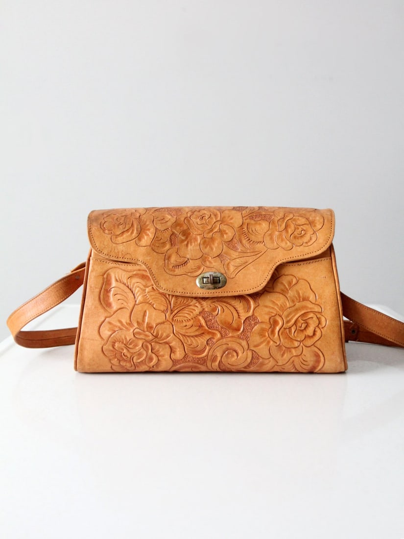 Vintage 70S Tooled Leather Bag: Vintage 70S Tooled Leather Bag This is a 1970s tooled leather shoulder bag. A classic western floral pattern sweeps across the honey leather bag. It has a long adjustable shoulder strap that can be wo