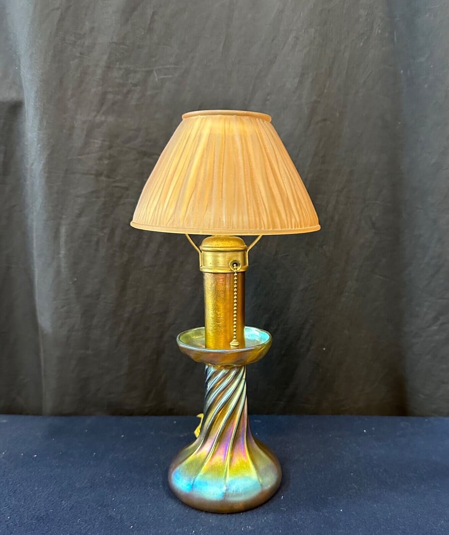 Tiffany Studios New York Candlestick Lamp: Tiffany Studios New York Candlestick Lamp Design: Tiffany Light Color: Pink Type: Candlestick Lamp Power Source: Corded Electric Color: Multicolor Cord Color: Yellow Style: Art Nouveau Material: Glass