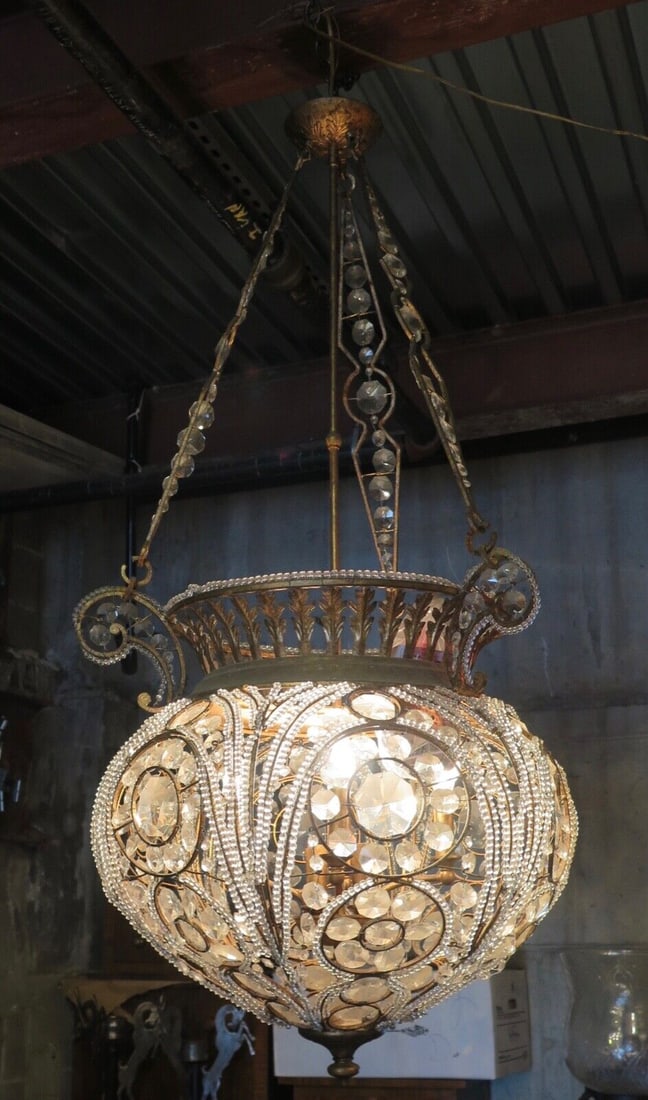 Vintage Quezal Crystal Chandelier: Vintage Quezal Crystal Chandelier Type: Chandelier This exquisite modern day Quezal crystal chandelier is beautifully designed with a solid hand made iron frame molded into an elaborate urn shape fixt