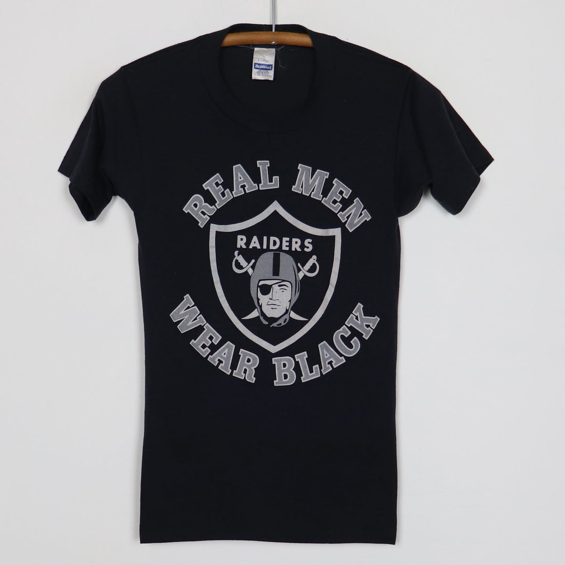 1980s Los Angeles Raiders Real Men Wear Black Shirt: 1980s Los Angeles Raiders Real Men Wear Black Shirt Original 1980s Los Angeles Raiders Real Men Wear Black Shirt. This is a true vintage shirt, not a modern reproduction. Sizes vary so please use meas