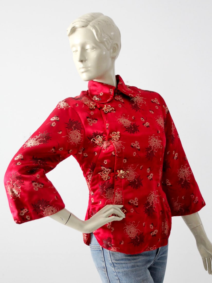 Vintage Chinese Brocade Jacket: Vintage Chinese Brocade Jacket This is a vintage Chinese silk jacket. Rich red satin brocade shapes the womens jacket with a black cream and gold floral pattern. The coat is padded and features a roun