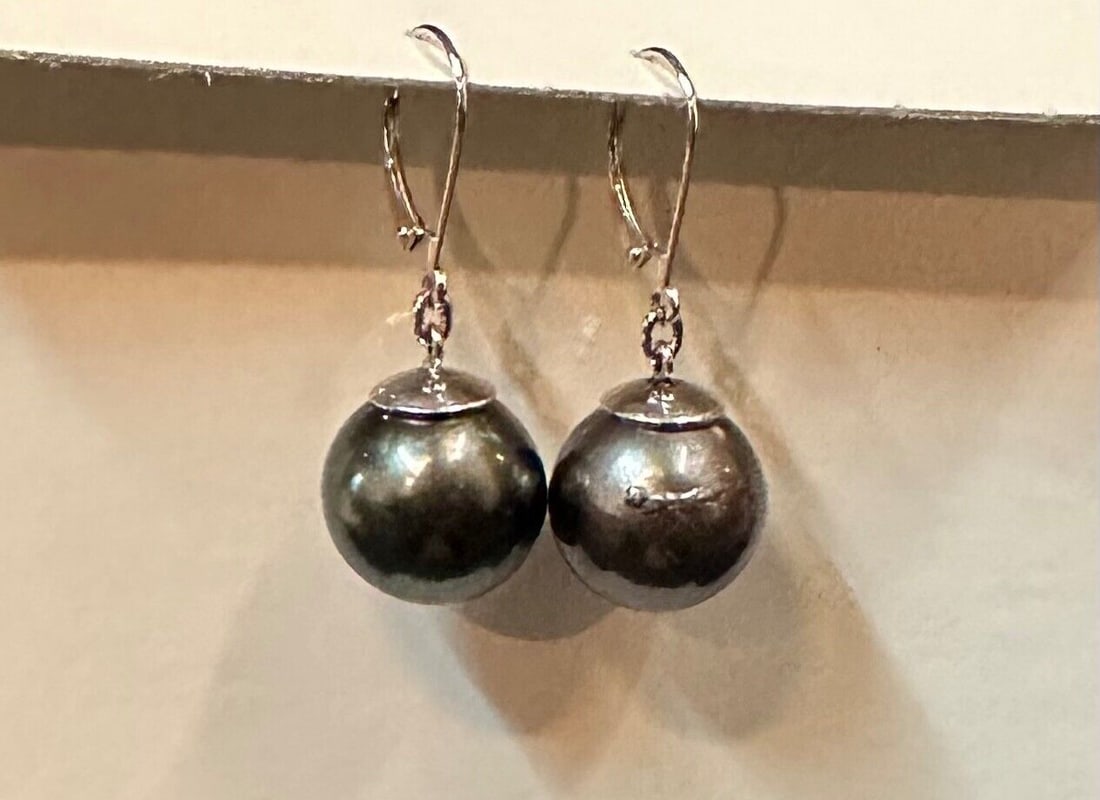 15 mm Black Pearl Dangle Earrings: 15 mm Black Pearl Dangle Earrings This fashionable pair of ladies earrings are beautifully designed with lustrous oversize black (Tahitian) pearls that dangle. These 15 mm pearl gems are suspended fro