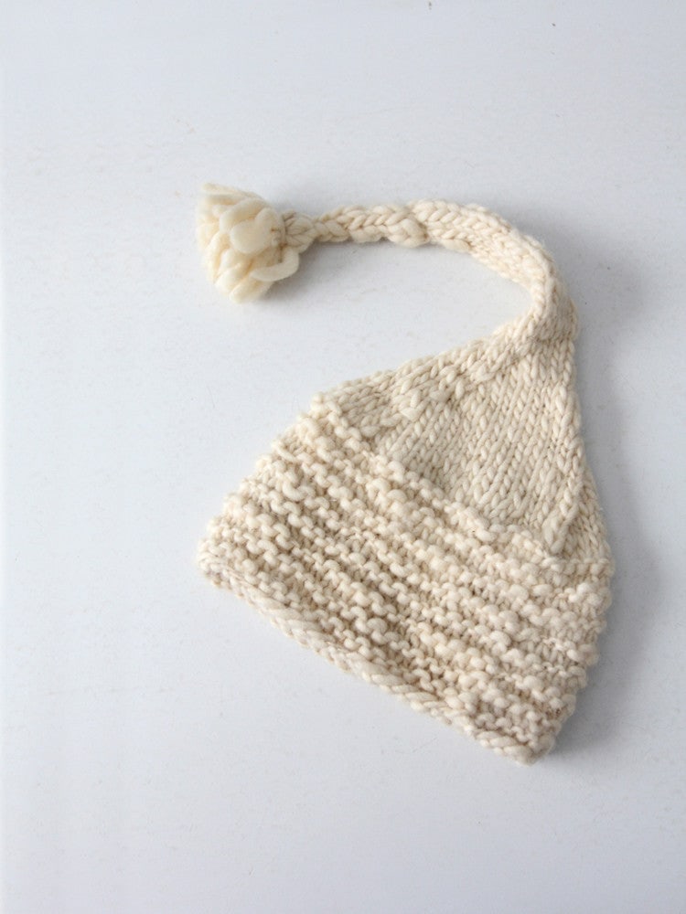 Vintage Knit Ski Hat With Long Tassel: Vintage Knit Ski Hat With Long Tassel This is a vintage cream knit tassel hat. Ultra-soft the cream knit hat features a ruffled cable pattern and a long elf-like tassel top. Width when flat 9 inch 22.