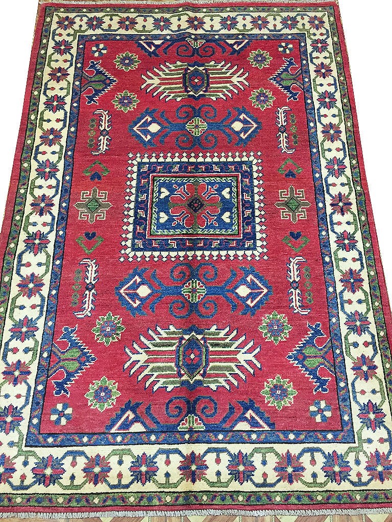 4 x 6 Handmade Pakistan Kazak Wool Rug: 4 x 6 Handmade Pakistan Kazak Wool Rug Free continental US Shipping Size in Feet: Width: 4.1 x Length: 6.1 Size in Inches: Width: 49 in x Length: 73 in Rug Type: Area Rug Colors: Red Ivory Blue Weave: