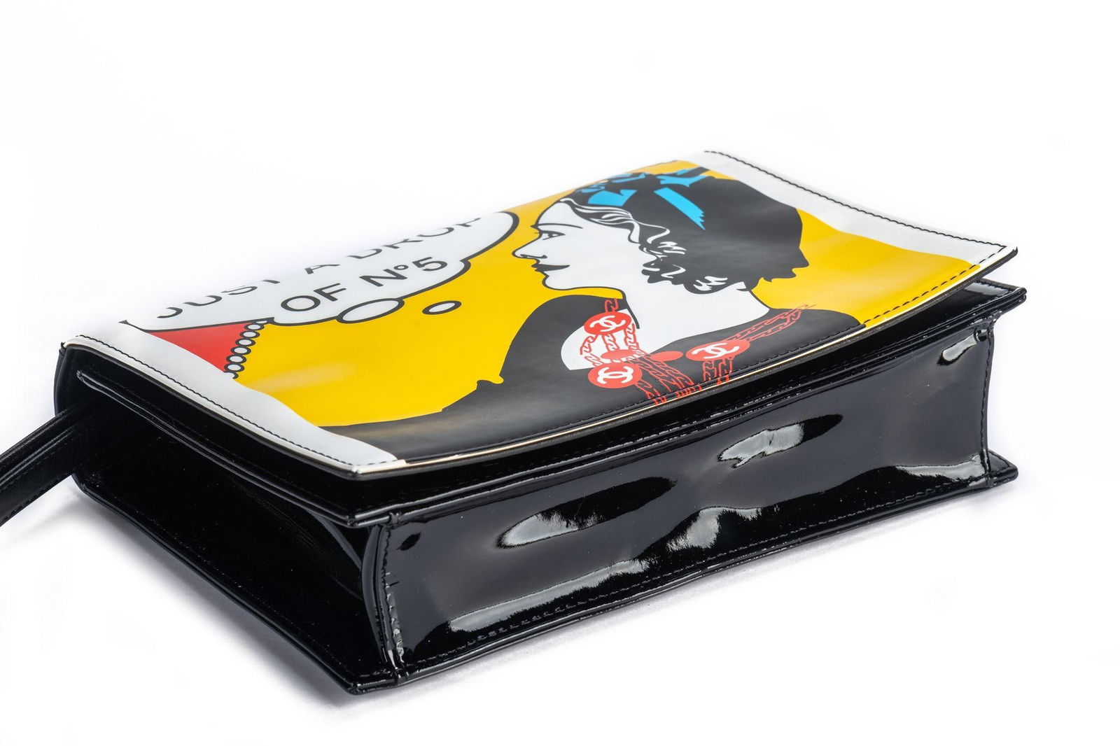 Chanel BNIB Coco Comics Clutch Bag: Chanel BNIB Coco Comics Clutch Bag Designer: Chanel Dimensions: Height: 6.5 in (16.51 cm)Width: 2.5 in (6.35 cm)Length: 8.75 in (22.23 cm) Place of Origin: Italy Period: 21st Century Pre-Owned The Myn