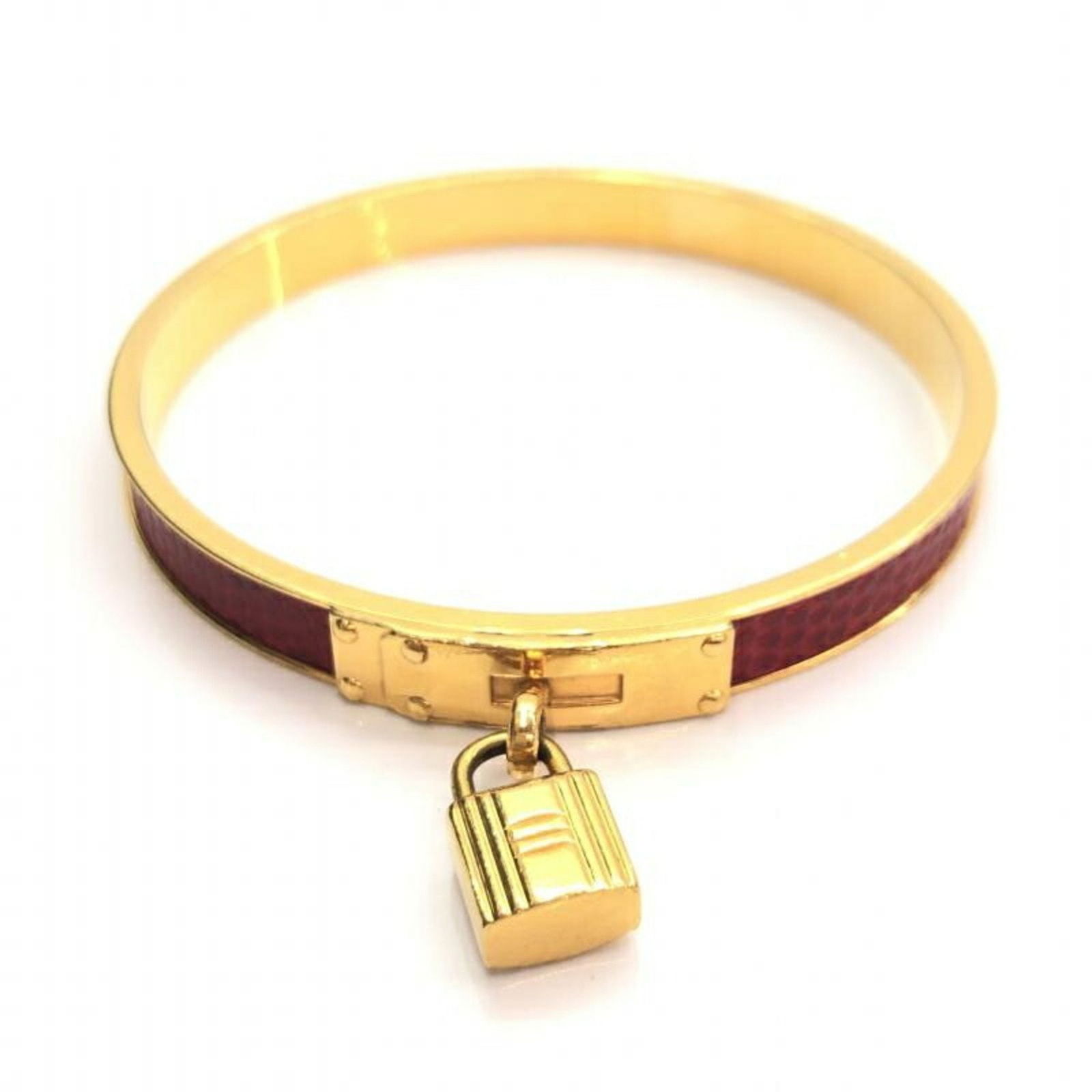 HERMES Kelly Bangle Brown Gold Hermes: HERMES Kelly Bangle Brown Gold Hermes Brand: Hermes Type: Bangle Gender: Women Material: Gold Color: Brown Diameter: 23cm / 9.05 Condition: Used (very good) Overall Scratches: Slight Overall Traces of