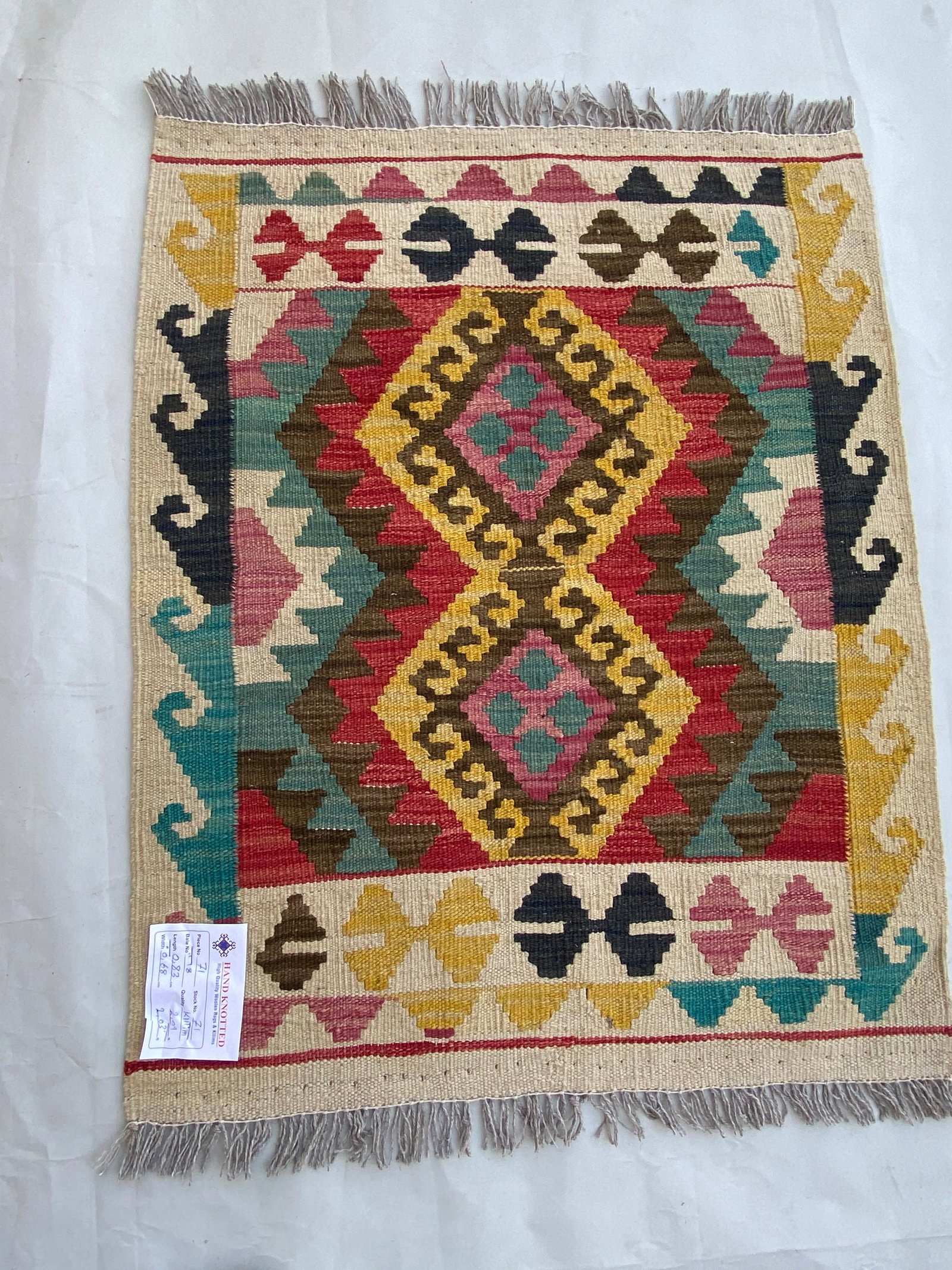 2 x 3 Multi-Color Red Handmade Geometric Kilim Rug: 2 x 3 Multi-Color Red Handmade Geometric Kilim Rug Free continental US Shipping Size in Feet: Width: 2 x Length: 3 Size in Inches: Width: 24 in x Length: 36 in Colors: MultiColor Red Ivory Light Brown