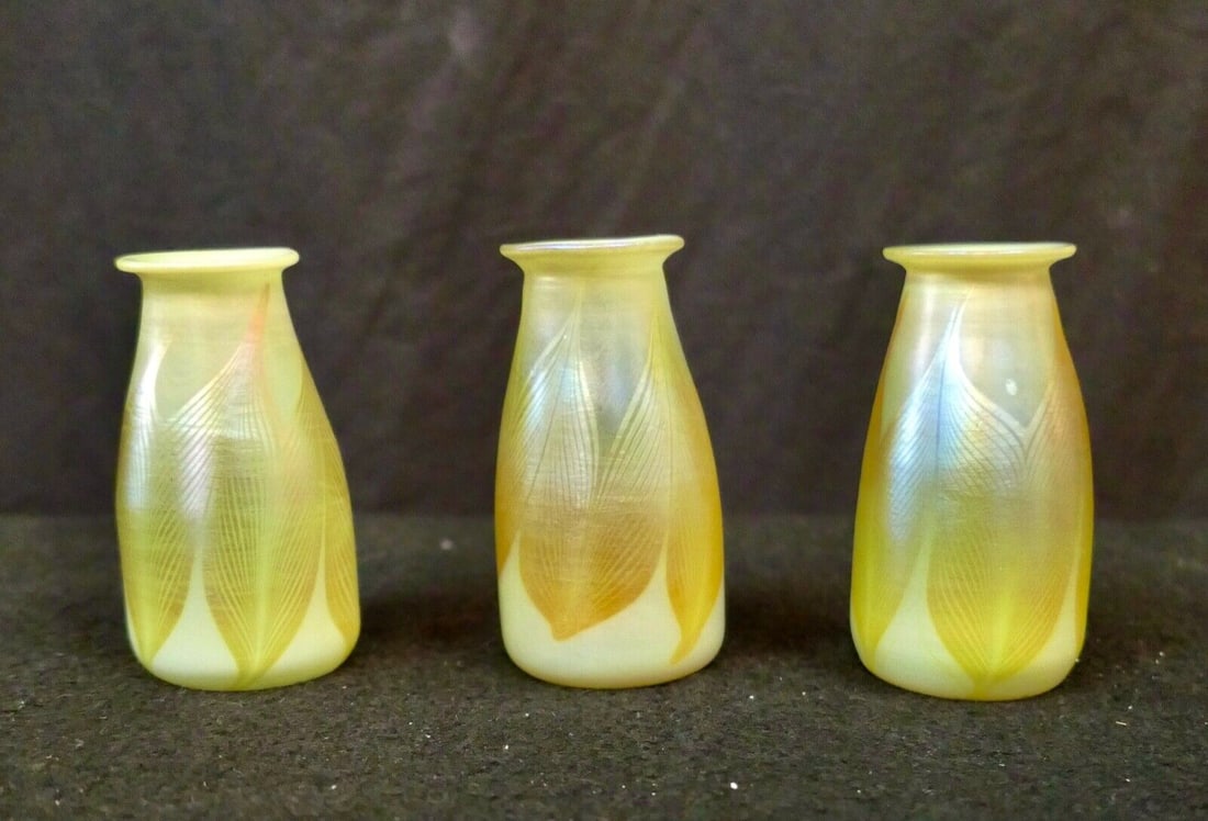 Three Tiffany Studios Favrile Art Glass Candle Lamp Shades: Three Tiffany Studios Favrile Art Glass Candle Lamp Shades Size: Small Pattern: pulled feather Type: lamp shade Color: gold iridescent Vintage: Yes Time Period Manufactured: 1900-1919 Style: Art Nouve