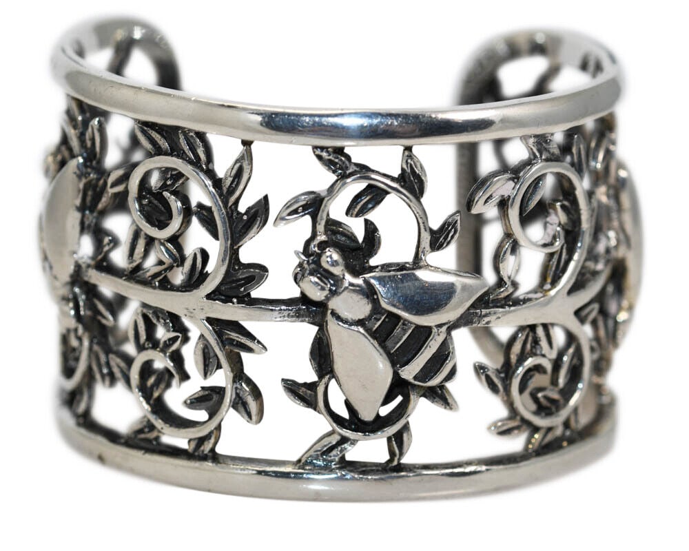 Sterling Silver Bumble Bee Bangle Bracelet: Sterling Silver Bumble Bee Bangle Bracelet This un-used sterling silver bangle bracelet features a charming floral bumble bee design. Handmade with excellent craftsmanship, it is stamped with 925 puri