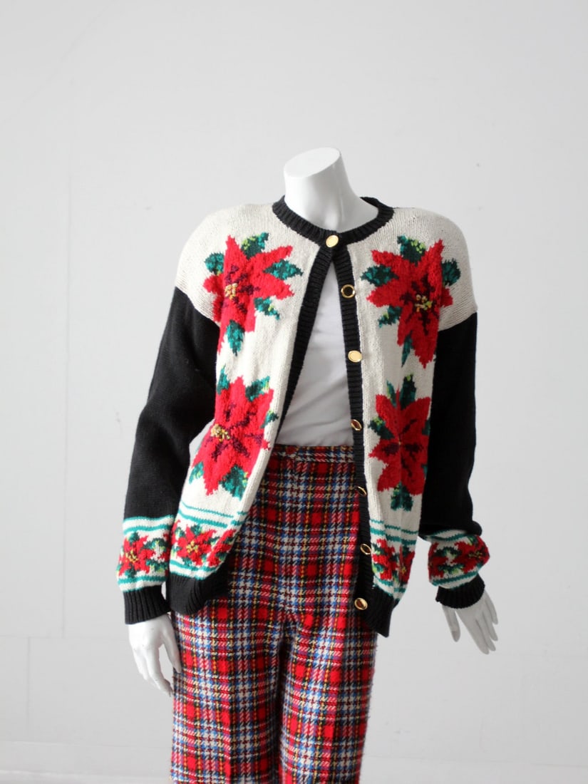 Vintage 90S Christmas Sweater: Vintage 90S Christmas Sweater This is a 1990s vintage Christmas "ugly" sweater. A holiday poinsettia pattern adorns the black white green and red cardigan with shimmering gold thread detailing the poi
