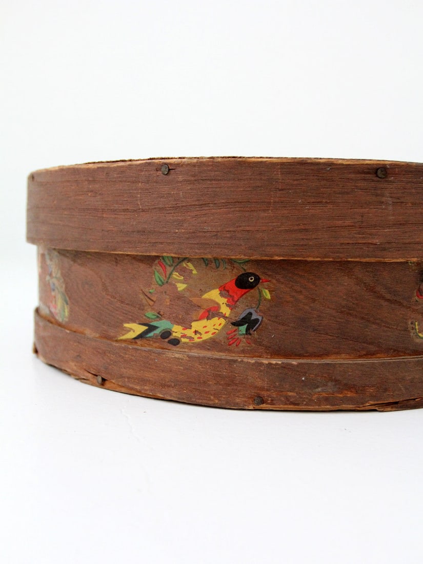 Antique Folk Art Cheese Box with Hand-Painted Design: Antique Folk Art Cheese Box with Hand-Painted Design This antique folk art cheese box features intricate hand-painted birds and flowers on its bentwood design. The rustic wood plank top lid adds to it