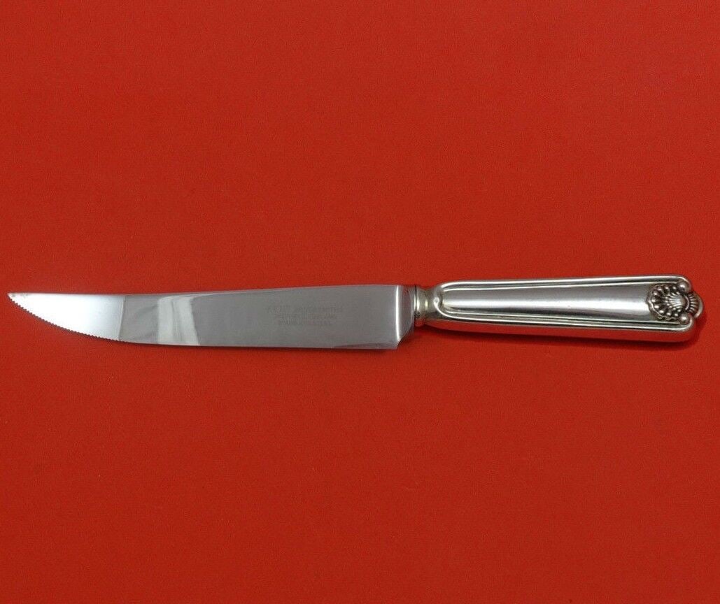 Fiddle Shell Sterling Silver Steak Knife by Frank Smith 8.5in Custom Made: Fiddle Shell Sterling Silver Steak Knife by Frank Smith 8.5in Custom Made This custom-made steak knife features a Fiddle Shell pattern by Frank Smith. Crafted from sterling silver, it has a hollow han