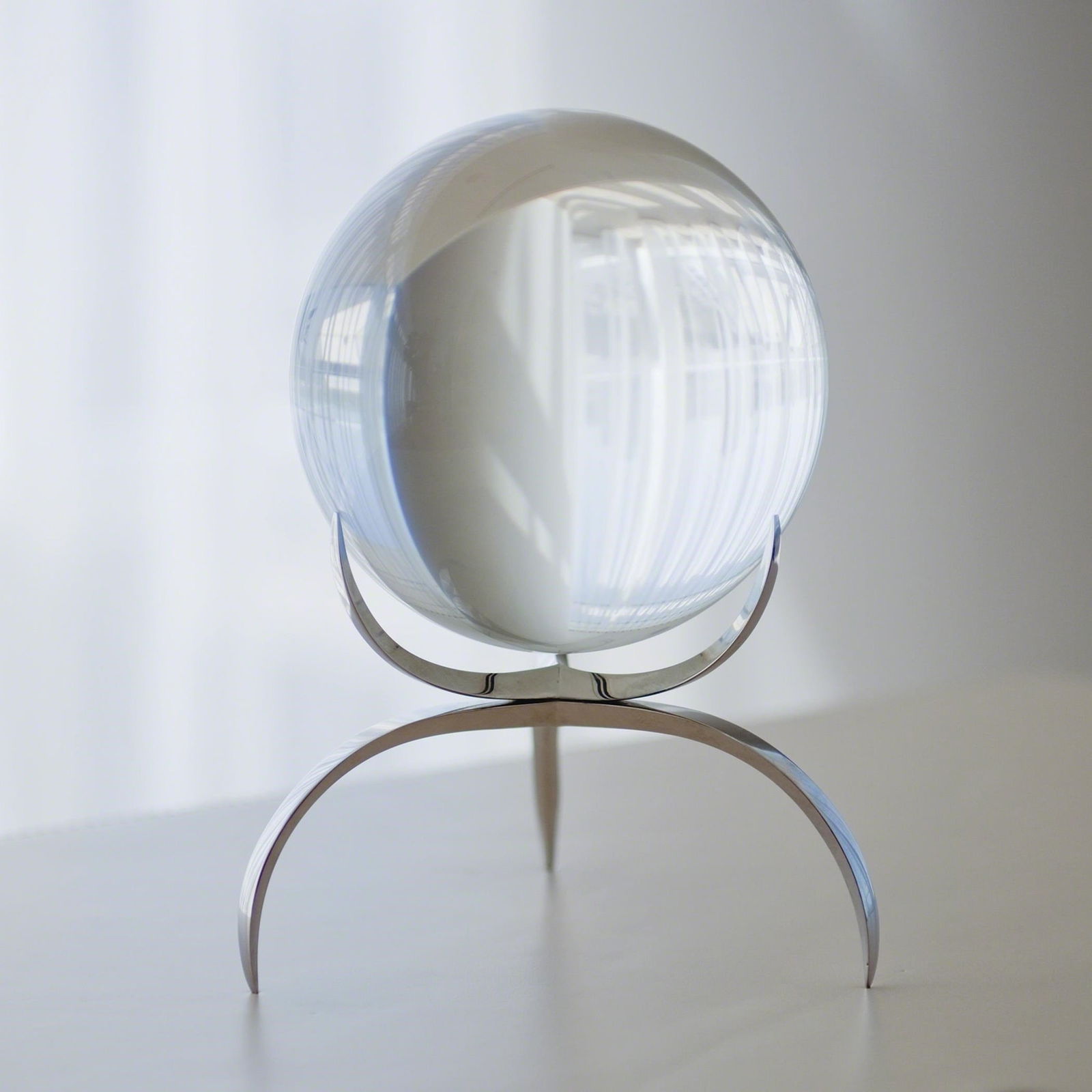 Clearlight Orb In Clear: Clearlight Orb In Clear This ojet d'art is a 12% lead crystal ball, five inches in diameter, that reflects light and will brighten up any room. It is held in a delicate three pronged base made of soli