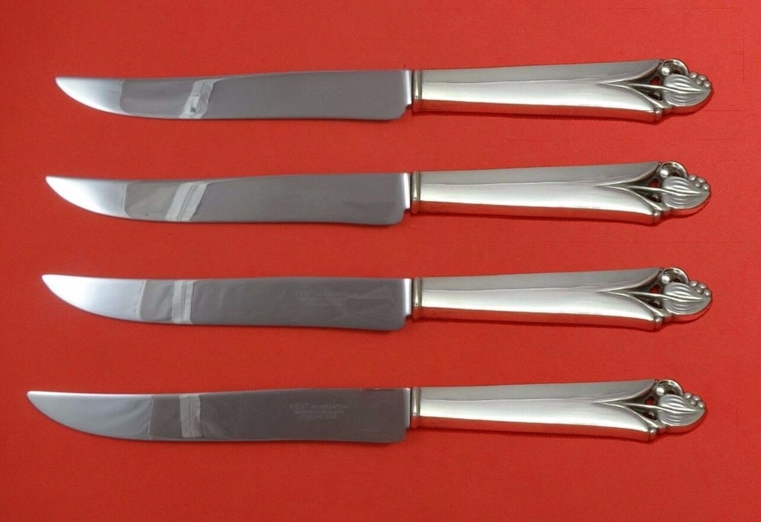 Woodlily Sterling Silver Steak Knife Set 4pc by Frank Smith: Woodlily Sterling Silver Steak Knife Set 4pc by Frank Smith This 4-piece Woodlily steak knife set by Frank Smith features sterling silver hollow handles paired with stainless steel blades. Each knife