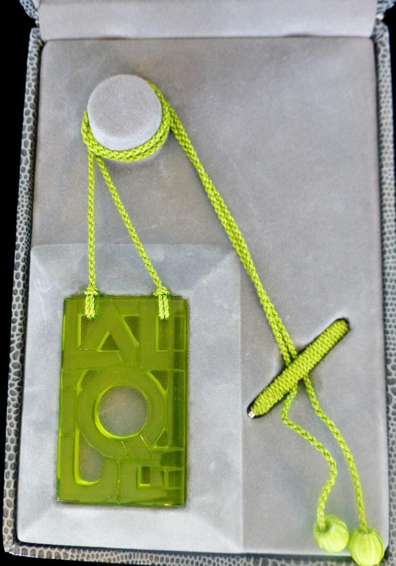 Lalique Green Deco Letter Crystal Pendant Necklace with Adjustable Silk Cord: Lalique Green Deco Letter Crystal Pendant Necklace with Adjustable Silk Cord This exquisite Lalique pendant necklace features a stunning green glass crystal pendant measuring 2 inches long by 1 inch w