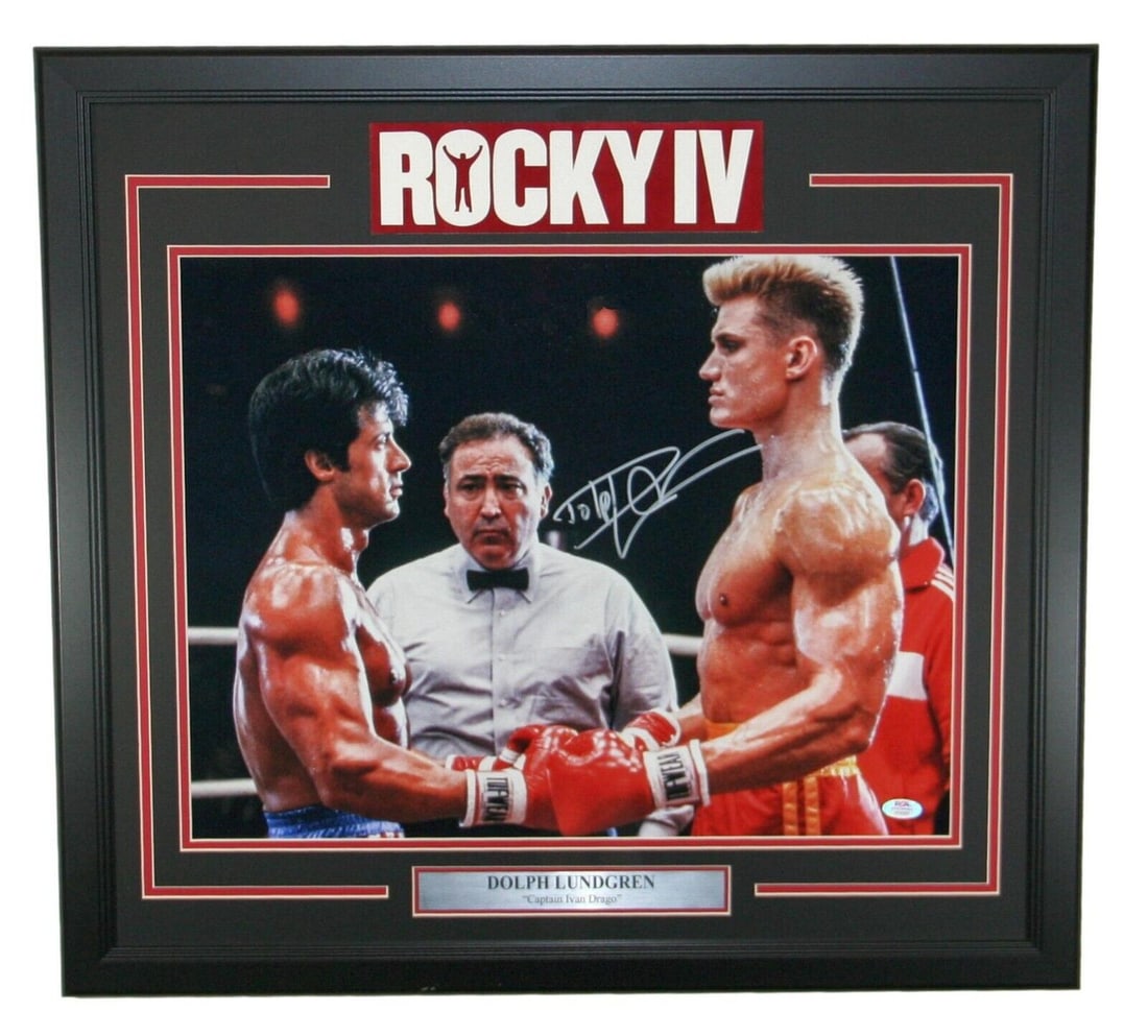 Dolph Lundgren Signed Captain Ivan Drago 16x20 Photo Framed PSA/DNA: Dolph Lundgren Signed Captain Ivan Drago 16x20 Photo Framed PSA/DNA This is an original 16x20 photograph of Dolph Lundgren as Captain Ivan Drago from the movie Rocky IV. The photo is framed and featur