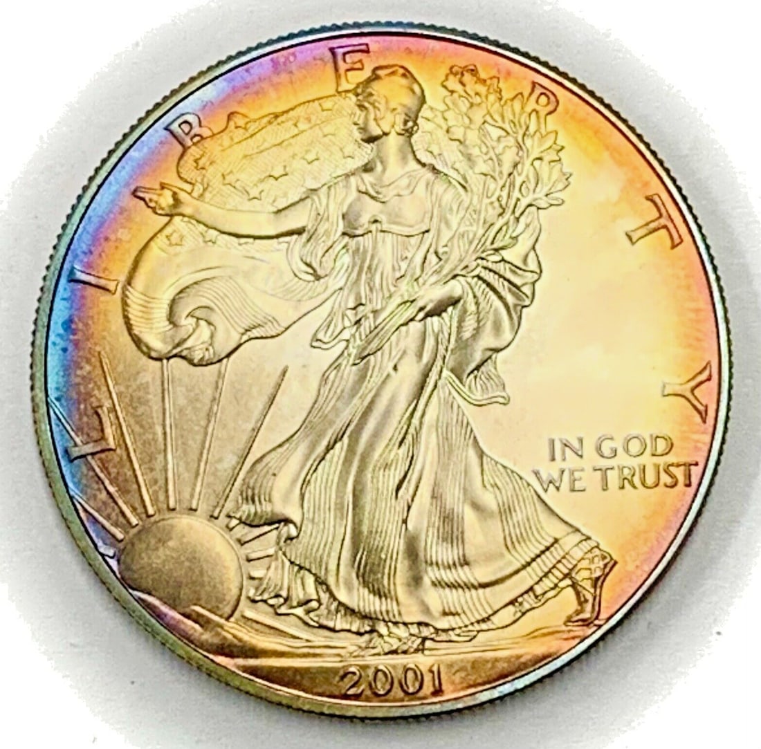 2001 American Silver Eagle Coin with Velvet Box: 2001 American Silver Eagle Coin with Velvet Box This 2001 American Silver Eagle coin features a stunning rainbow tone finish and comes with a velvet box. It has a denomination of $1 and is made of sil