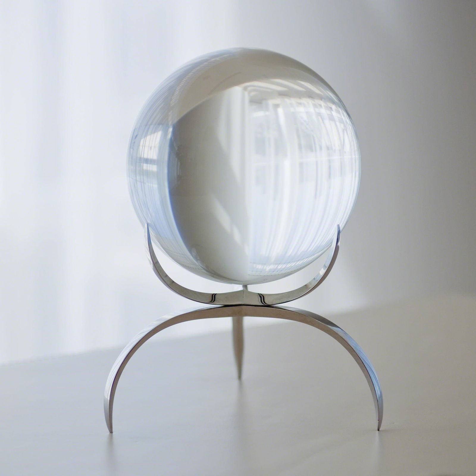 Clearlight Orb In Clear: Clearlight Orb In Clear This ojet d'art is a 12% lead crystal ball, five inches in diameter, that reflects light and will brighten up any room. It is held in a delicate three pronged base made of soli
