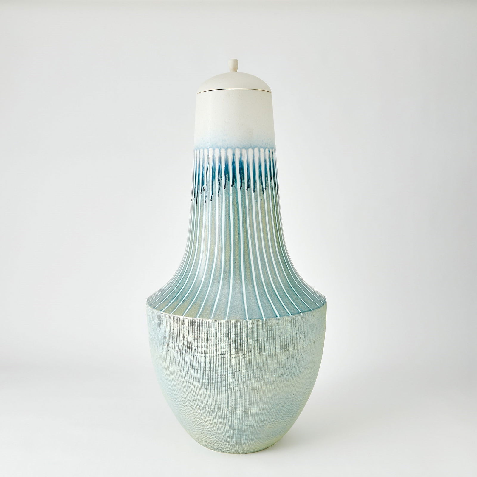 Striped Flair Urn In Lambs Ear: Striped Flair Urn In Lambs Ear Crafted by Portuguese artisans, the Striped Flair Collection is made of slip-molded ceramic with a lamb's ear and white striped finish. Each stripe is hand-painted with