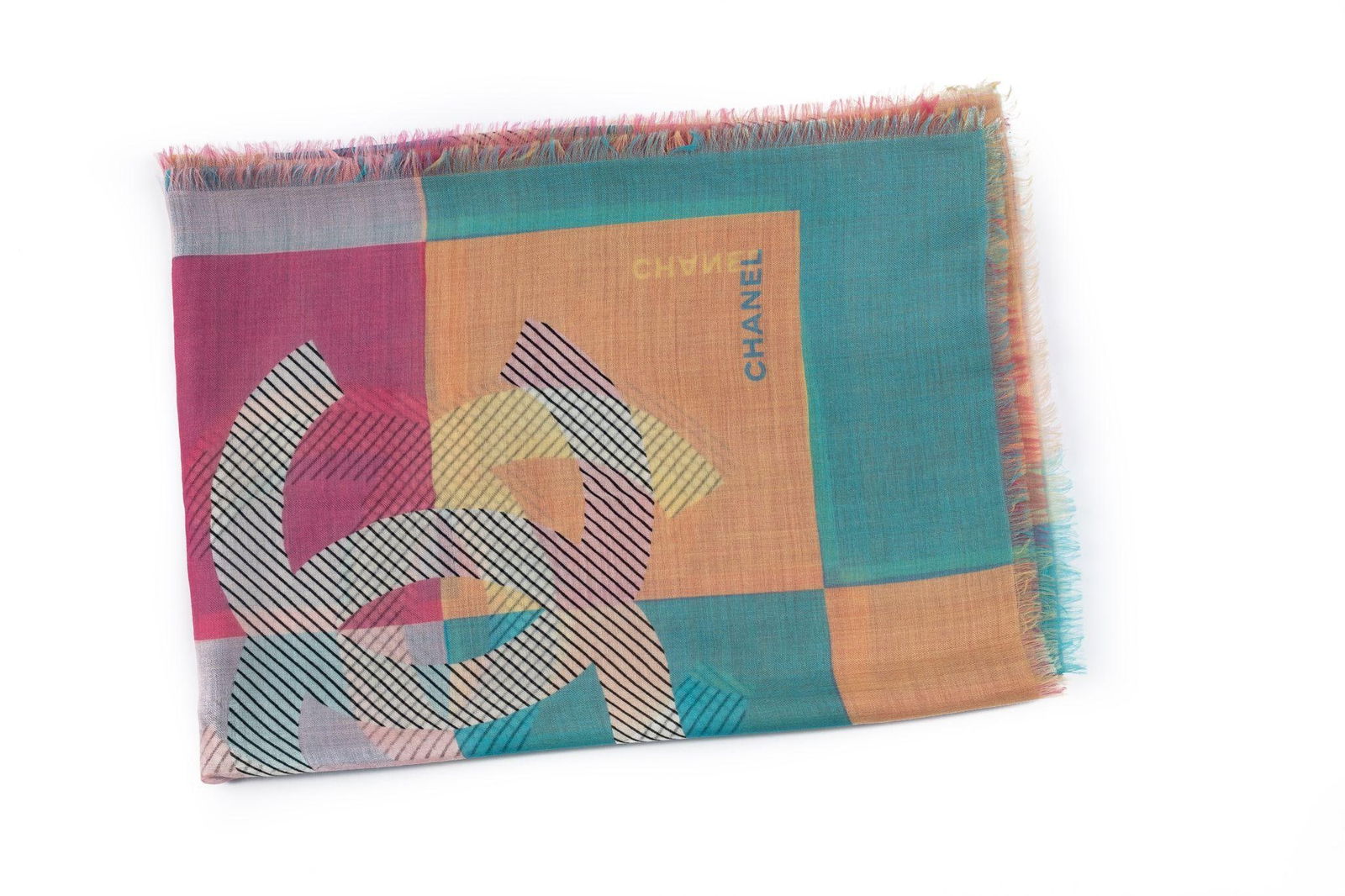 Chanel Multicolor Checkers Shawl 52in x 78in Silk Made in Italy 21st Century: Chanel Multicolor Checkers Shawl 52in x 78in Silk Made in Italy 21st Century This stunning multicolor checkers shawl by Chanel features a geometric pattern and is made from silk. With dimensions of 52