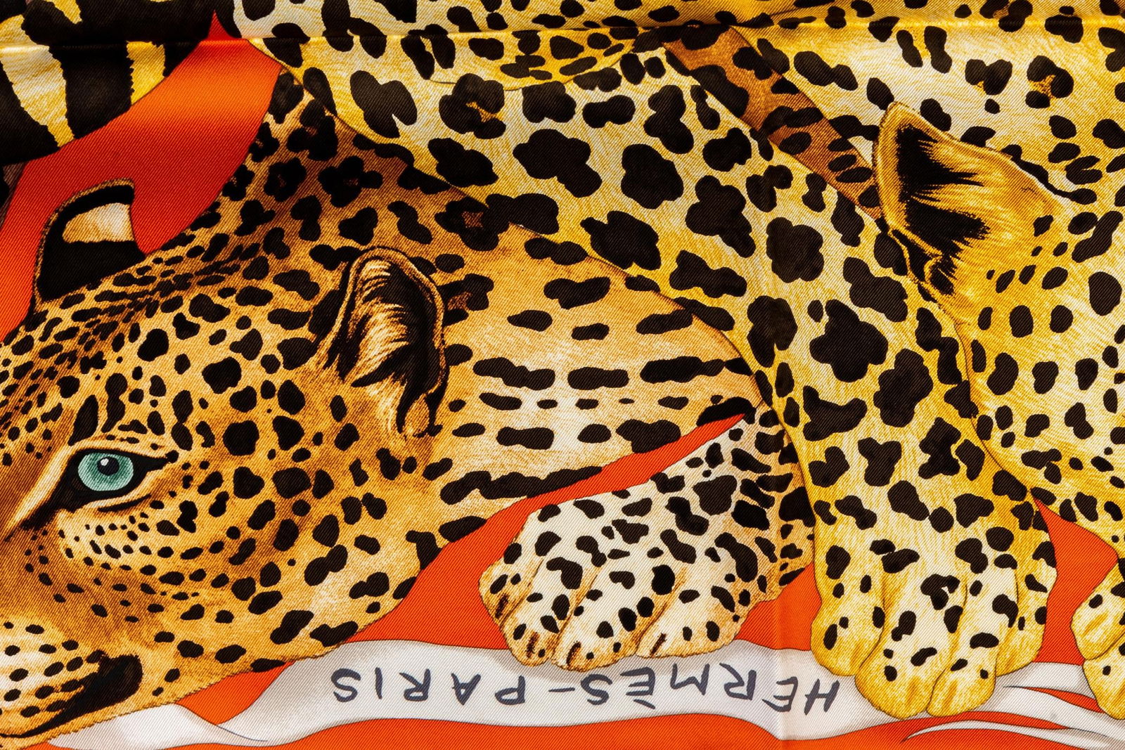Hermes Leopard Print Silk Scarf 35in Orange France 21st Century: Hermes Leopard Print Silk Scarf 35in Orange France 21st Century This stunning Hermes silk scarf features a vibrant leopard print design in orange and black. It measures 35 inches by 35 inches (88.9 cm