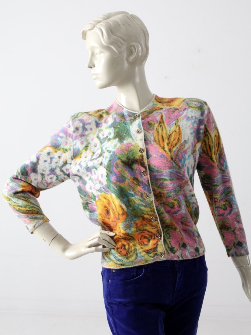 Vintage Floral Patterned 60s Ste. Laurent Cardigan: Vintage Floral Patterned 60s Ste. Laurent Cardigan This vintage 60s Ste. Laurent cardigan features a charming floral pattern and a button front design. It offers an approximate fit of medium, with key