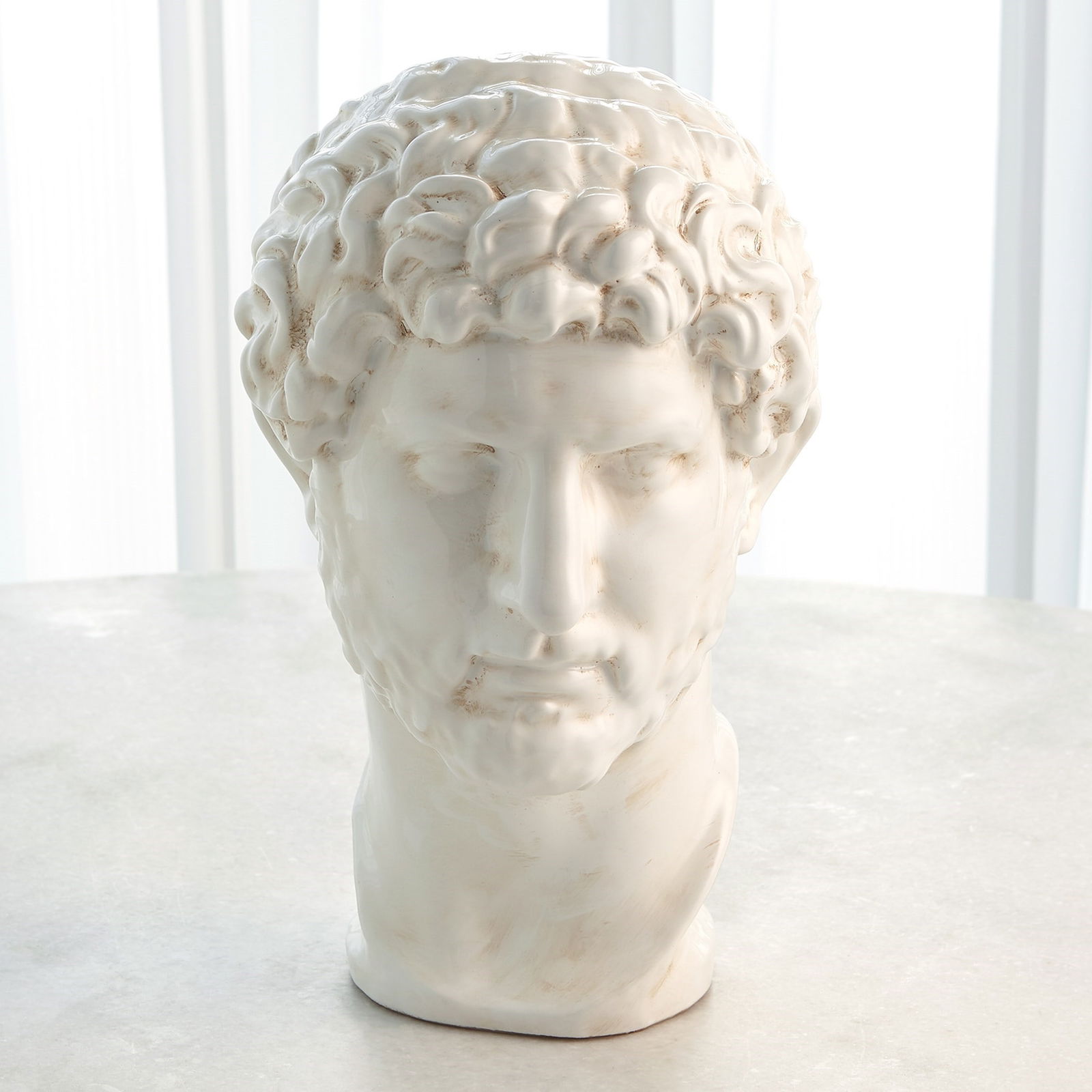 Hadrian Bust In White Glaze: Hadrian Bust In White Glaze Our Hadrian Bust is made from terracotta-based ceramic, formulated in a method the Italians refer to as "calco", the act of packing a perfectly produced mold with terracott