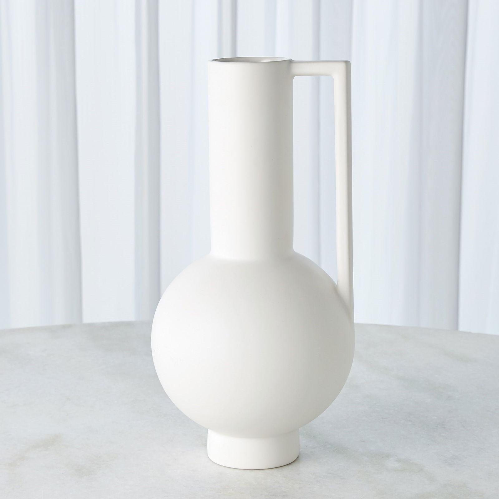Classic Pitcher With Handle In Matte White: Classic Pitcher With Handle In Matte White This Portuguese ceramic pitcher has an exquisite reactive glaze similar to that found on Greco-Roman serveware. Item Dimensions: Height: 15.25 Width: 7.75 De