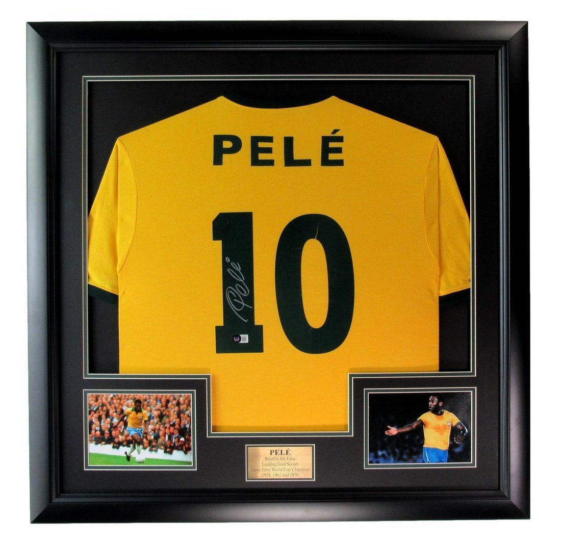 Pele Signed Brazil Soccer Jersey Framed Beckett 184945: Pele Signed Brazil Soccer Jersey Framed Beckett 184945 This is an original signed Brazil soccer jersey featuring the iconic Pele. The jersey is framed for display, making it an ideal piece for collect