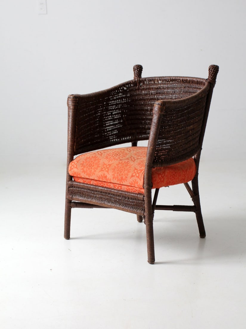 Vintage S. Karpen Brothers Wicker Chair with Floral Cushion: Vintage S. Karpen Brothers Wicker Chair with Floral Cushion This is a S. Karpen Brothers chair circa 1920s. The hand-crafted brown wicker chair features a barrel back with an orange floral upholstered
