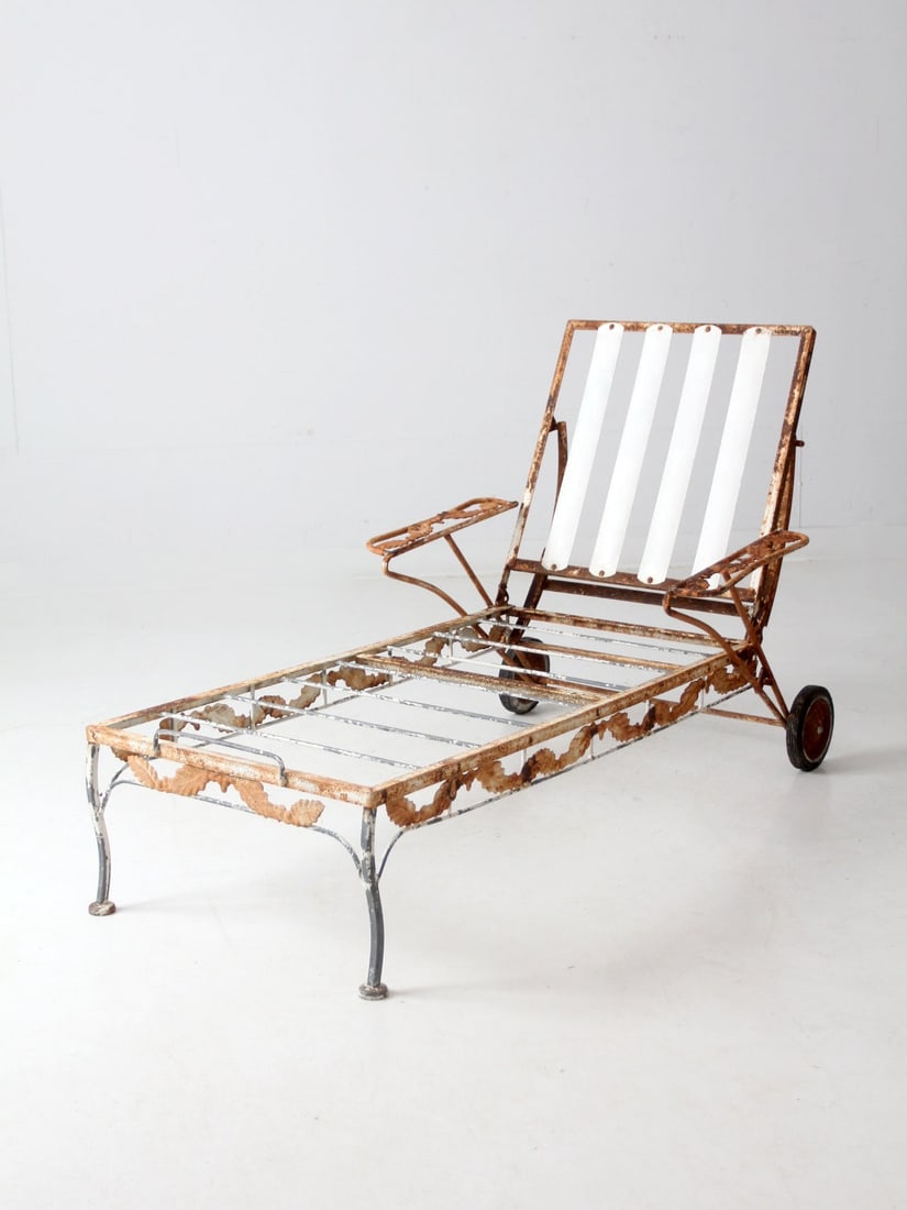 Mid 20th Century Vintage Wrought Iron Chaise Lounge Chair with Scrolling Leaf Pattern: Mid 20th Century Vintage Wrought Iron Chaise Lounge Chair with Scrolling Leaf Pattern This mid 20th century vintage wrought iron chaise lounge chair showcases a weathered white finish and features a s