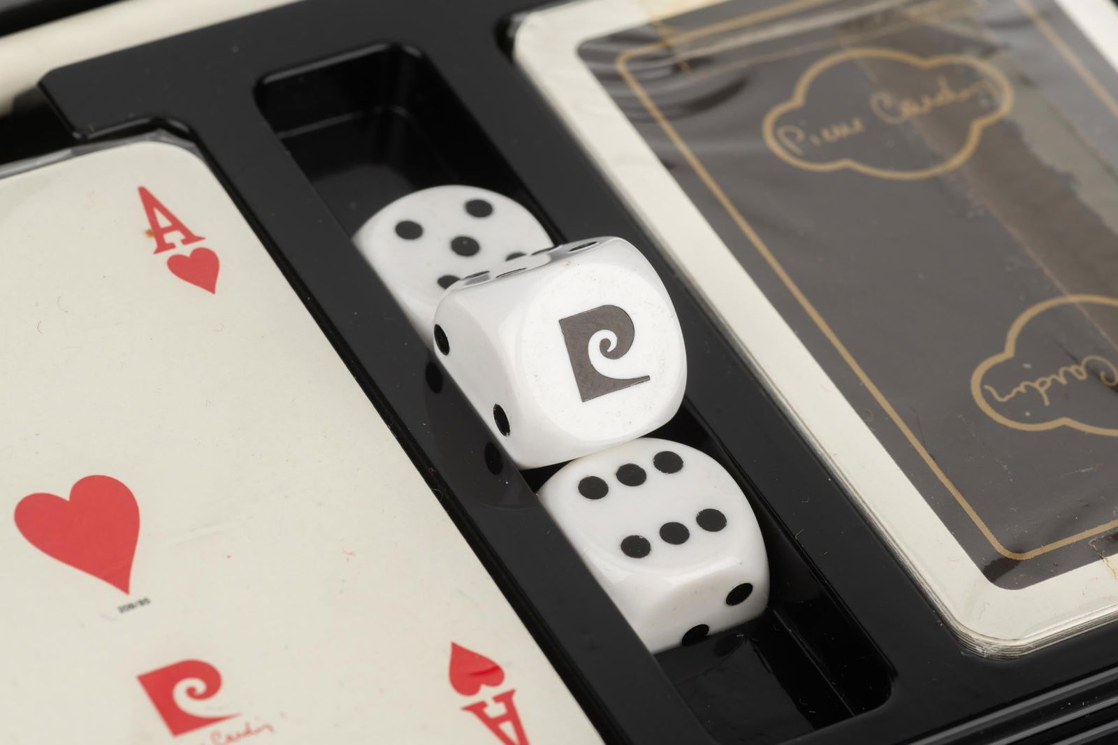 Pierre Cardin Vintage Poker Set with Glossy Black Lacquered Box: Pierre Cardin Vintage Poker Set with Glossy Black Lacquered Box This exquisite vintage poker set by Pierre Cardin features a sleek black lacquered box with a glossy finish, adorned with a striking red