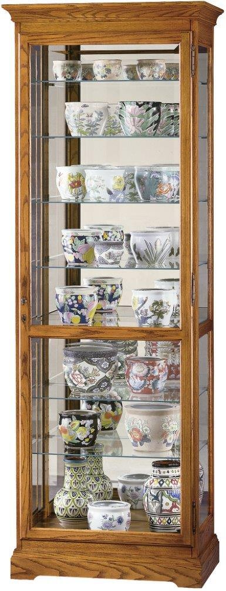 Howard Miller Chesterfield II Curio Cabinet Golden Oak Adjustable Shelves Lighting: Howard Miller Chesterfield II Curio Cabinet Golden Oak Adjustable Shelves Lighting Showcase your decorative objects with the Chesterfield II curio cabinet. This glass display cabinet is crafted with s