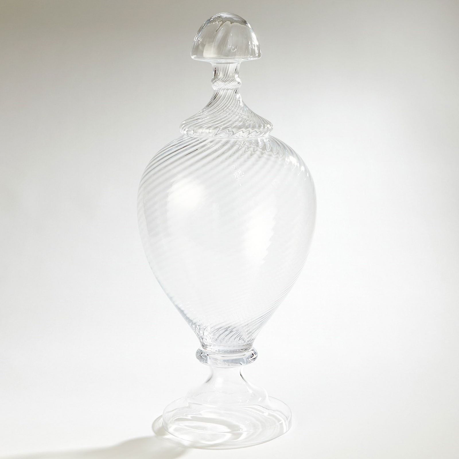Elegant Spiraled Glass Lidded Jar 31 Inches Unique Design: Elegant Spiraled Glass Lidded Jar 31 Inches Unique Design The Spiraled Glass Lidded Jar is a visually stunning piece that will add a touch of elegance to any home decor. Crafted from molten glass that