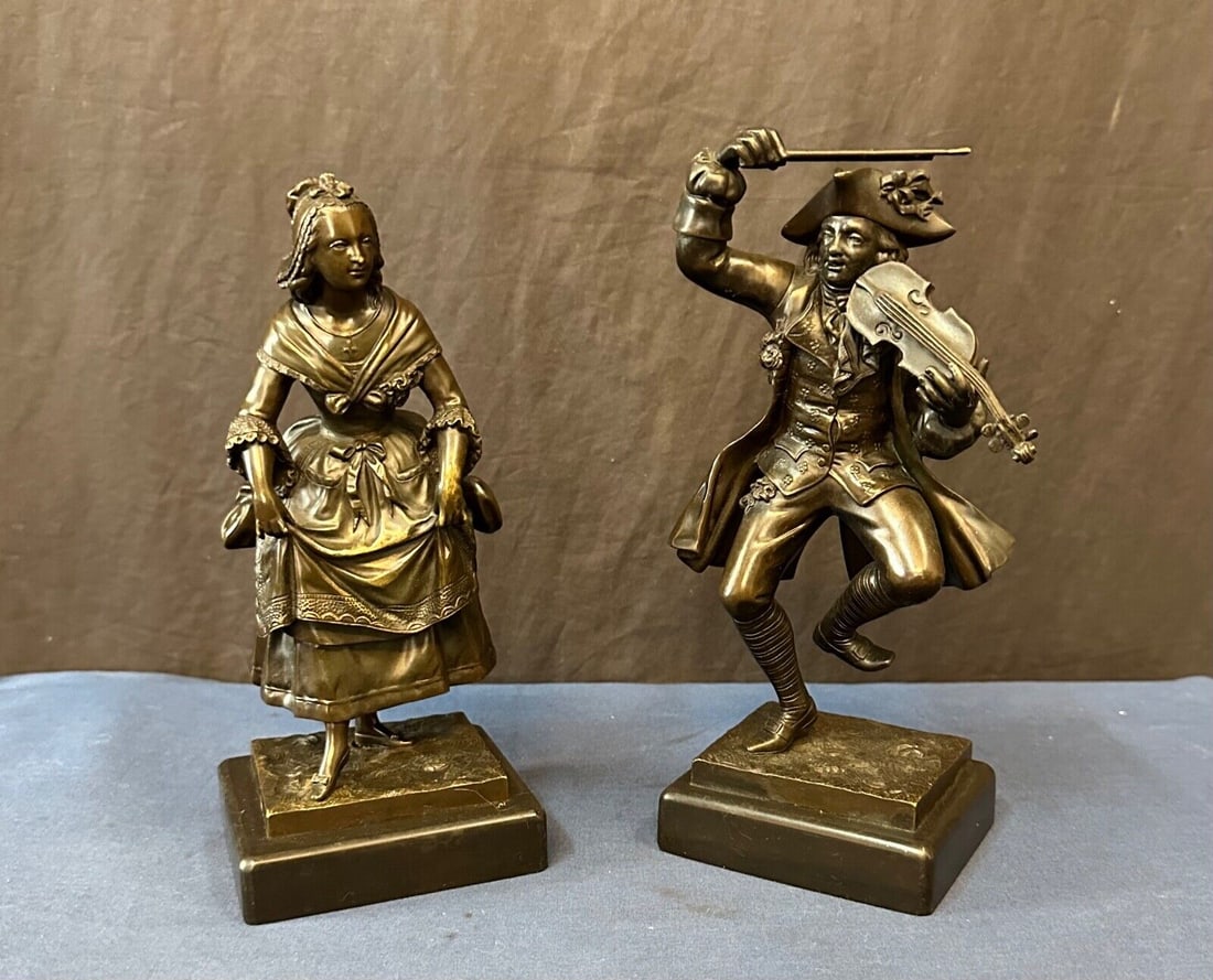 Mid 19th Century Bronze Dance Sculptures on Marble Base: Mid 19th Century Bronze Dance Sculptures on Marble Base This pair of antique bronze sculptures captures the essence of rural French country life through intricate detail and festive dance poses. Each 