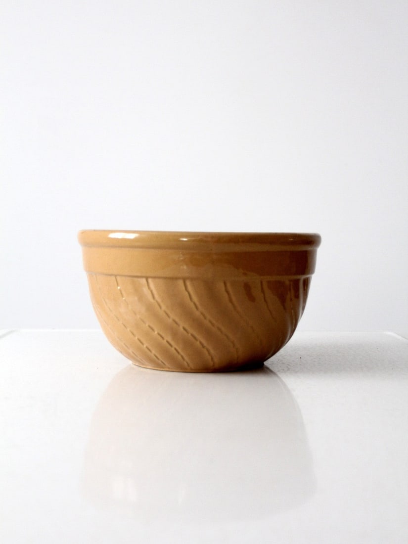Vintage 11 Inch Yellow Ware Stoneware Bowl with Dashed Pattern: Vintage 11 Inch Yellow Ware Stoneware Bowl with Dashed Pattern This vintage yellow ware bowl is a striking addition to any kitchen. Crafted from durable stoneware, it features a charming dashed curvin