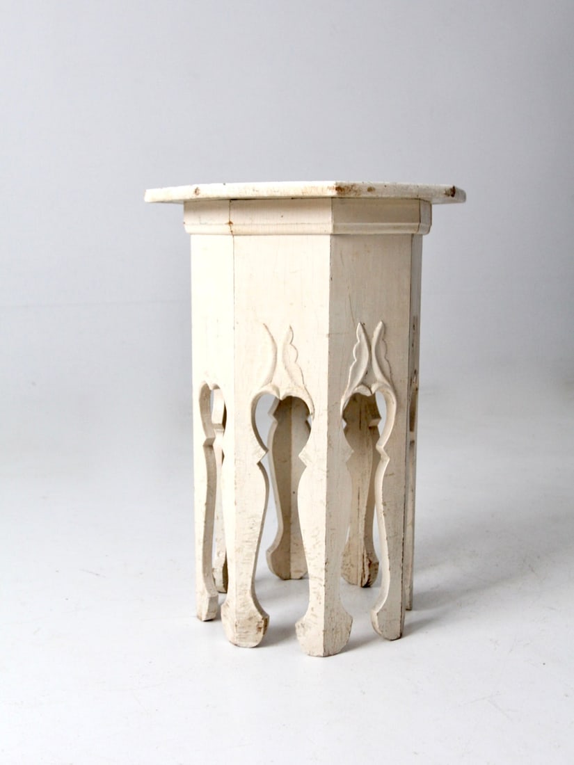 Antique Creamy White Octagonal Side Table with Carved Legs: Antique Creamy White Octagonal Side Table with Carved Legs This antique octagonal side table features a creamy white painted finish on a wooden pedestal. The table is supported by eight decoratively c