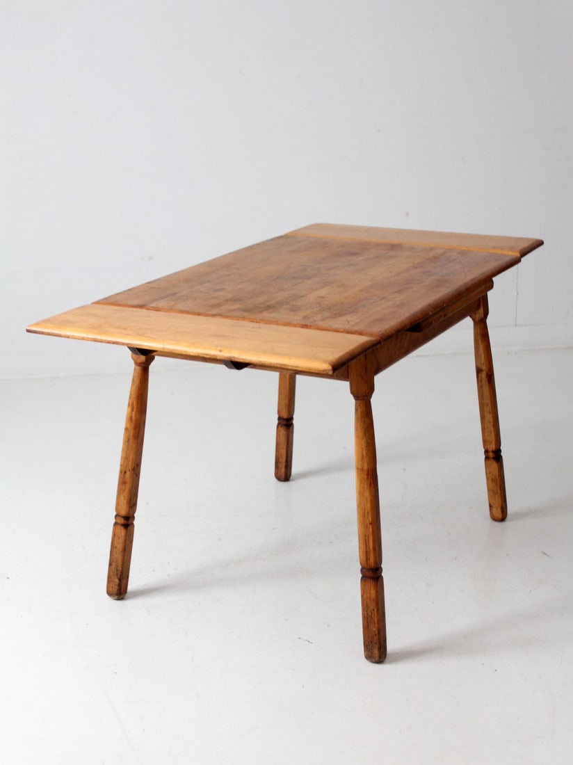 Mid-Century Vintage Pine Kitchen Table with Drop-Leaf Extensions: Mid-Century Vintage Pine Kitchen Table with Drop-Leaf Extensions This charming mid-century pine kitchen table features clever drop-leaf extensions on each end perfect for adjusting to your dining need