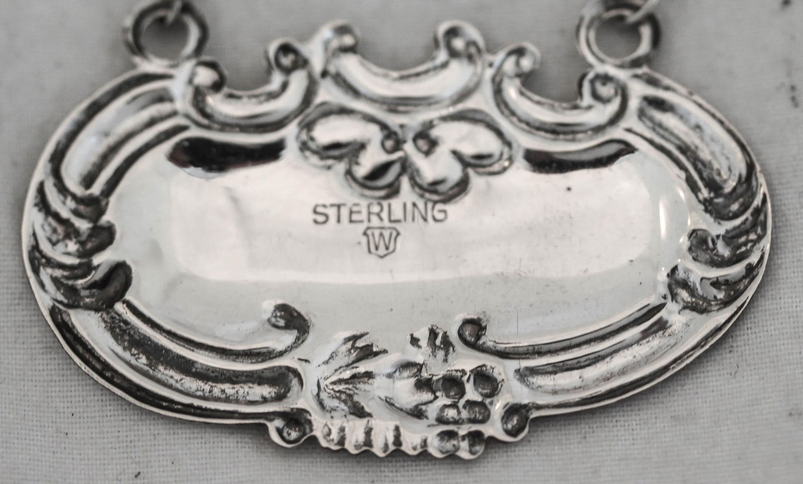 Sterling Silver Brandy Liquor Label by Wallace Silversmiths: Sterling Silver Brandy Liquor Label by Wallace Silversmiths This exquisite sterling silver brandy liquor label, crafted by Wallace Silversmiths, features a classic design. It measures 1 inch in height