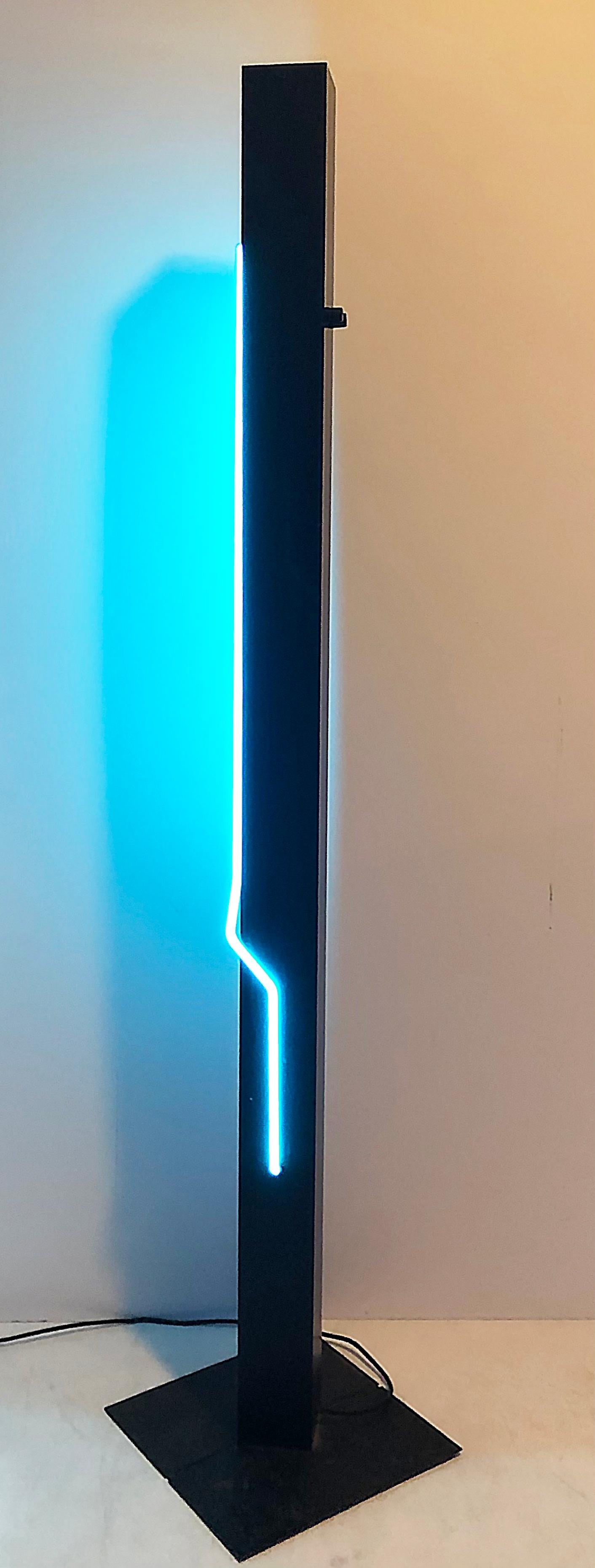 Postmodern Sculpture and Torchiere Lamp "Let There Be Neon": Postmodern Sculpture and Torchiere Lamp "Let There Be Neon" This striking Postmodern sculpture and torchiere lamp by Rudi Stern features a sleek vertical design enhanced by a captivating blue neon lig