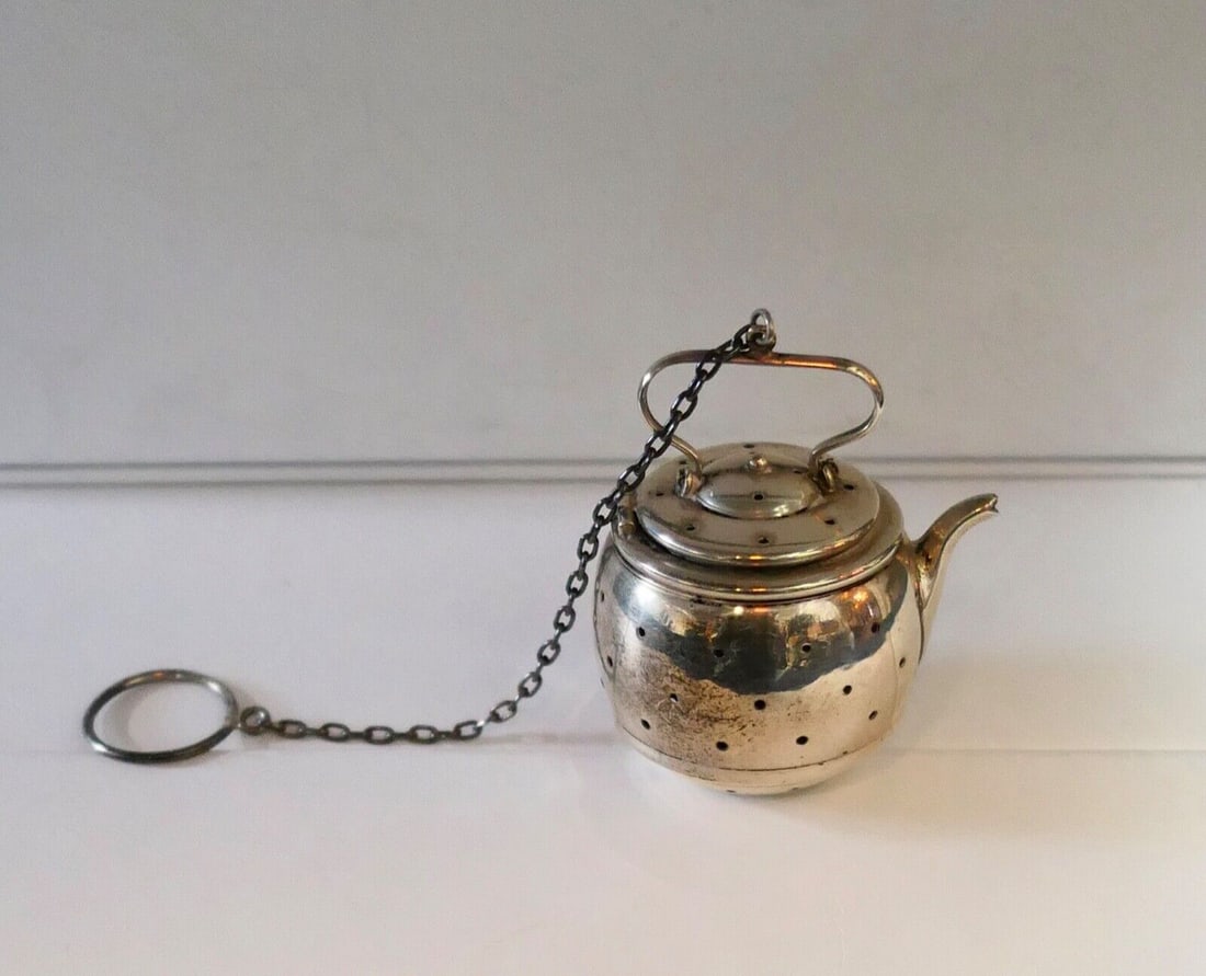 Vintage Sterling Silver Tea Kettle Strainer with Chain WC Hallmark: Vintage Sterling Silver Tea Kettle Strainer with Chain WC Hallmark This charming vintage sterling silver tea strainer is designed in the shape of a bulbous tea kettle with perforated body & solid spou