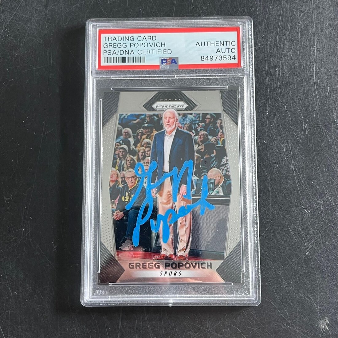 2017-18 Panini Prizm #300 Gregg Popovich Signed Card PSA/DNA Certified: 2017-18 Panini Prizm #300 Gregg Popovich Signed Card PSA/DNA Certified This is a trading card featuring Gregg Popovich, the esteemed head coach of the San Antonio Spurs. The card is a 2017-18 Panini P