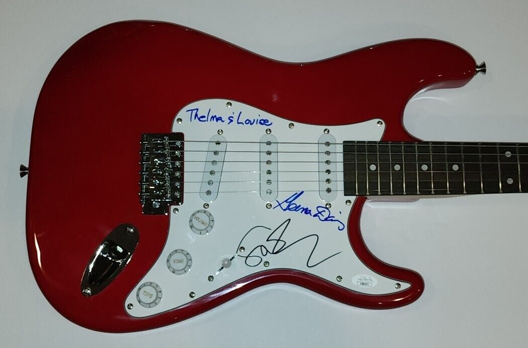 Susan Sarandon Genna Davis Signed Electric Guitar JSA: Susan Sarandon Genna Davis Signed Electric Guitar JSA This original electric guitar is signed by both Susan Sarandon and Geena Davis, celebrating their iconic roles in the film "Thelma & Louise." Auth