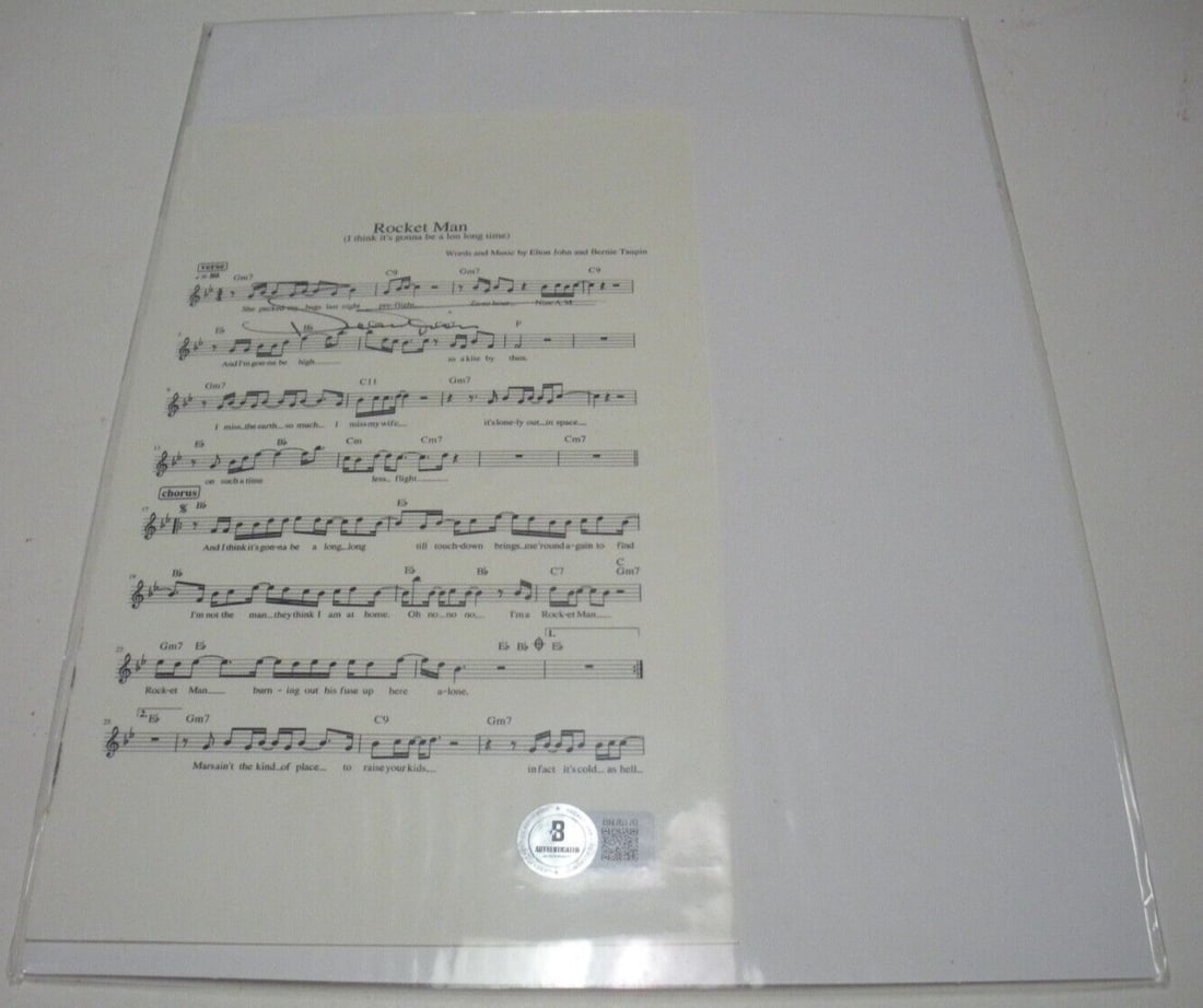 Bernie Taupin Rocket Man Elton John Signed Sheet Music: Bernie Taupin Rocket Man Elton John Signed Sheet Music This is a rare signed sheet music for the iconic song 'Rocket Man' by Elton John. Authenticated by Beckett, this original piece is a must-have fo