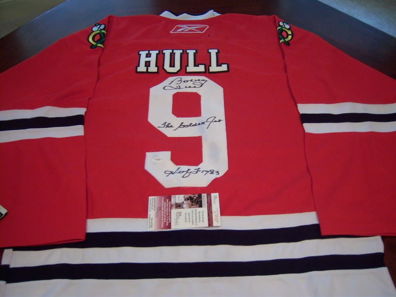 BOBBY HULL CHICAGO BLACKHAWKS HOF SIGNED OFFICIAL REEBOK JERSEY: BOBBY HULL CHICAGO BLACKHAWKS HOF SIGNED OFFICIAL REEBOK JERSEY This official Reebok hockey jersey is a must-have for any fan of the Chicago Blackhawks and Hall of Famer Bobby Hull. The vibrant red je
